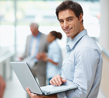 Software developer holding laptop computer